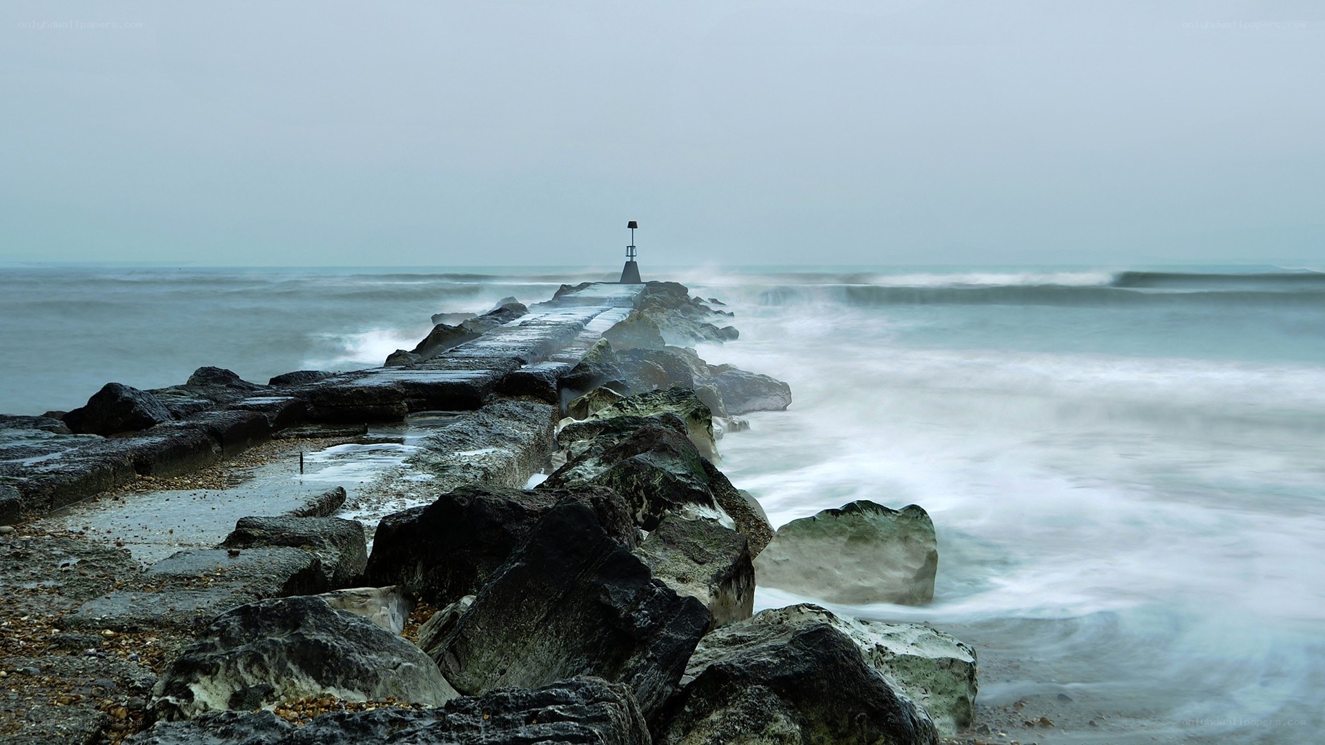 Rocky pier in stormy sea