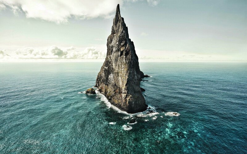 Rocky Sea Stack — Blue, Serene, Afternoon, Photograph, Ocean