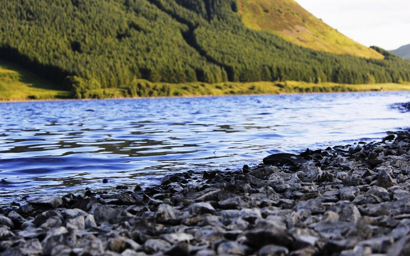 Rocky Shore by Lake — Blue, Serene, Afternoon, Photograph, Mountain