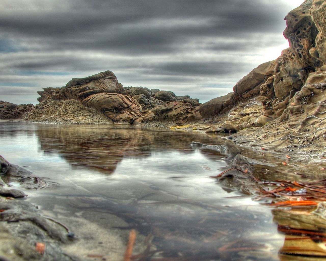 Rocky shore under cloudy sky