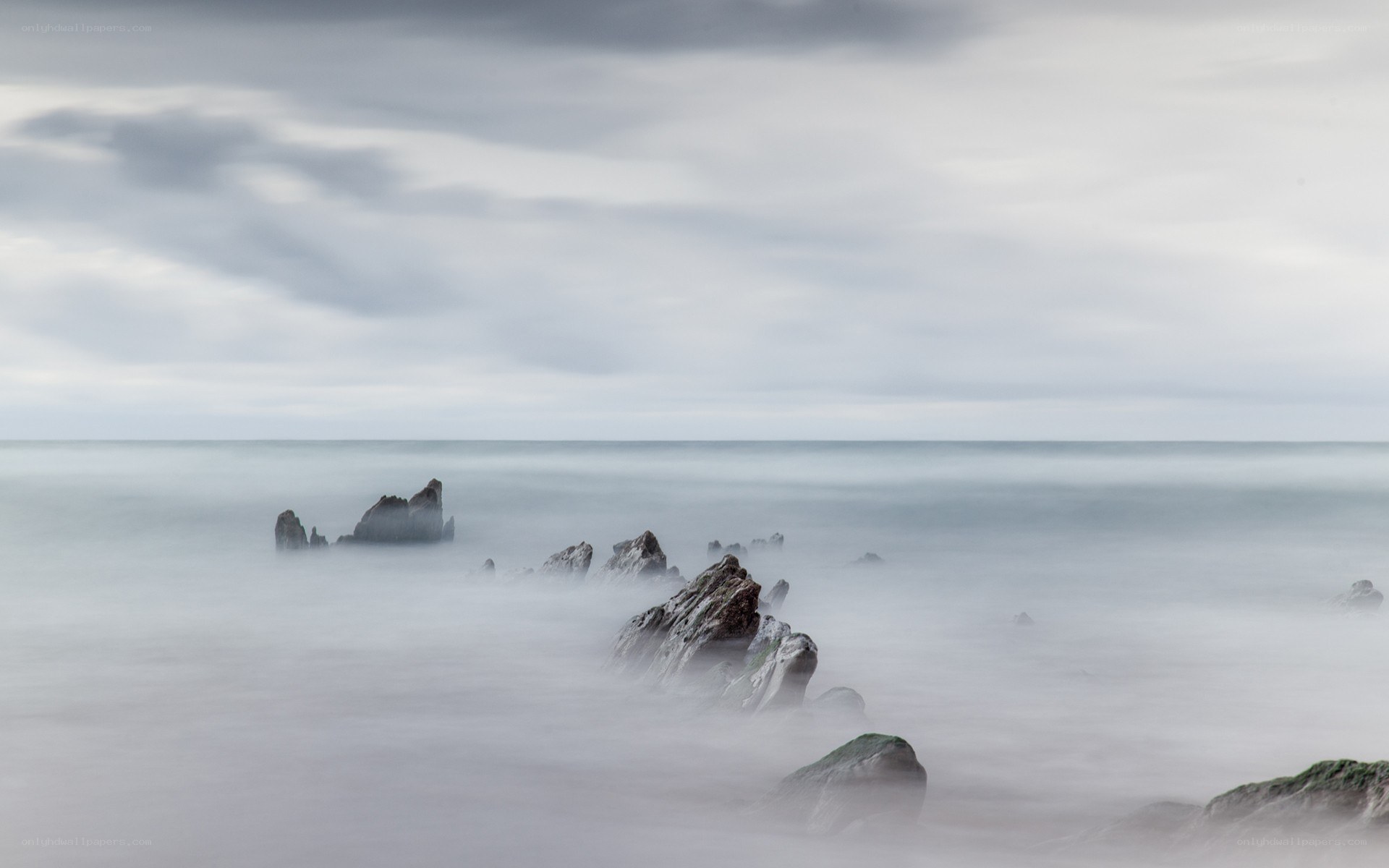Rocky shore under cloudy sky