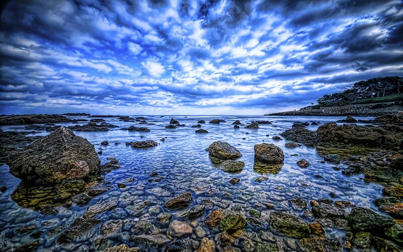 Rocky shore under cloudy sky