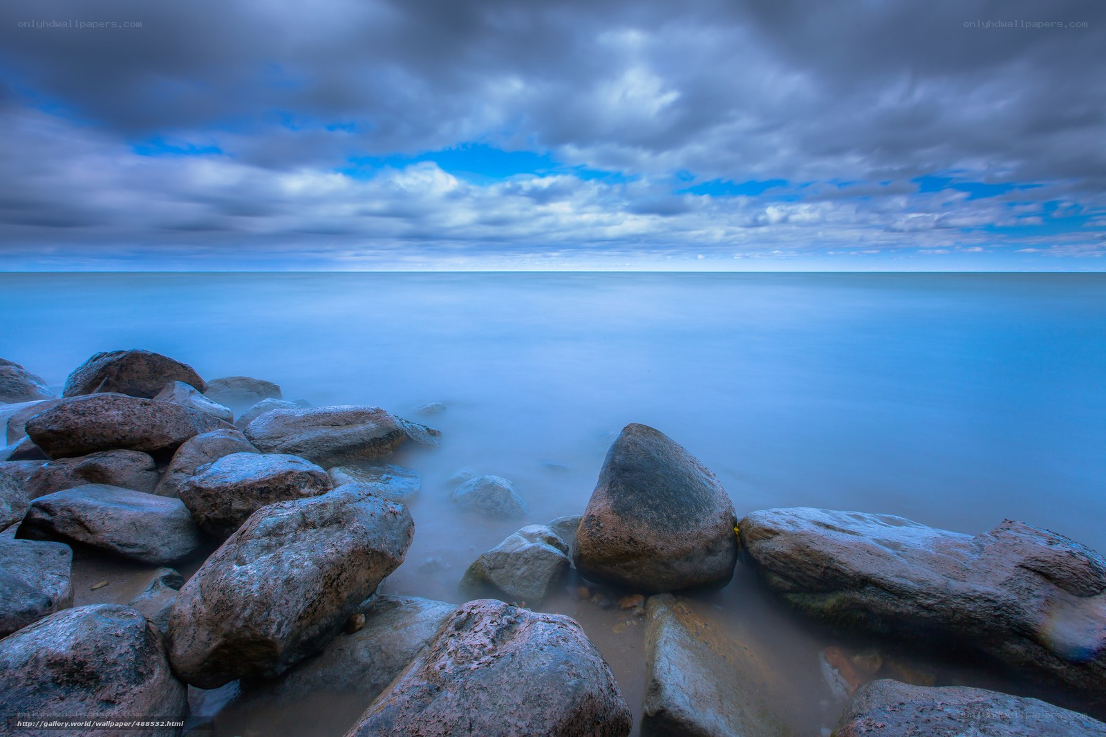 Rocky shore under cloudy sky