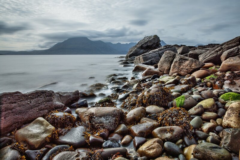 Rocky shore with distant mountains