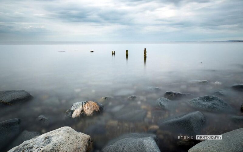 Rocky Shore with Wooden Posts