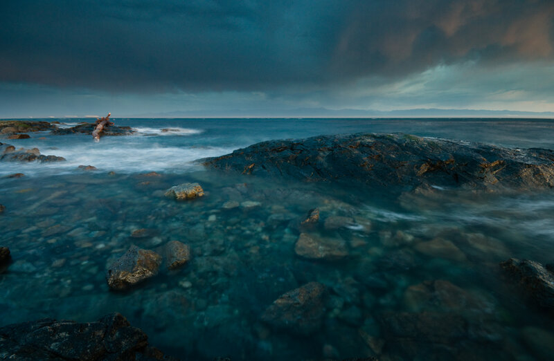 Rocky Shoreline at Dusk — Blue, Dramatic, Night, Photograph, Rocks