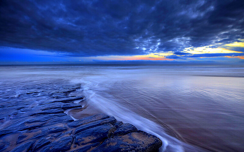 Rocky Shoreline at Dusk — Blue, Dramatic, Sunset, Photograph