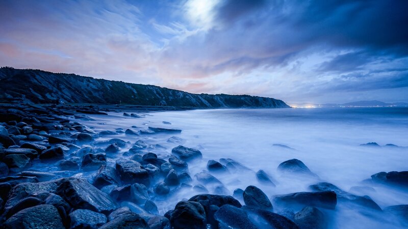 Rocky Shoreline at Dusk — Blue, Serene, Night, Photograph, Cliff