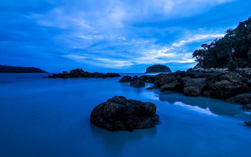 Rocky Shoreline at Dusk — Blue, Serene, Night, Photograph, Rocks, Sea, Island