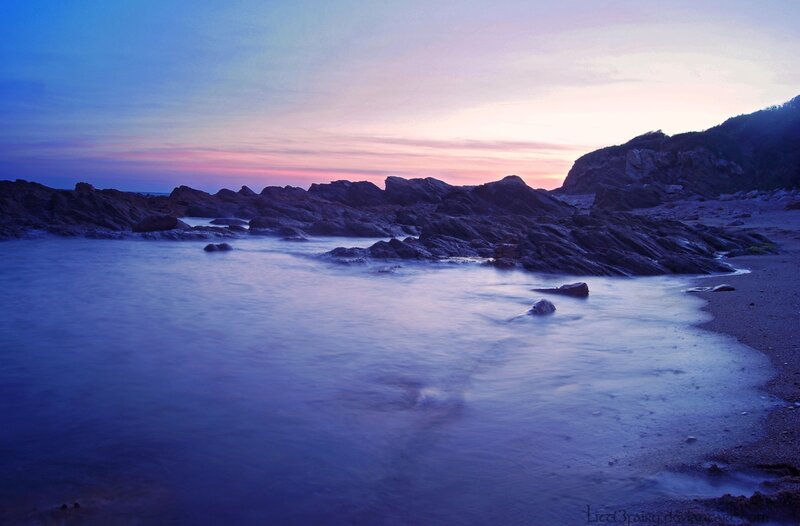 Rocky Shoreline at Dusk — Blue, Serene, Sunset, Photograph, Rocks, Beach