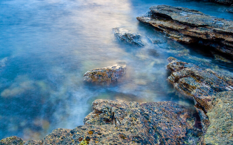 Rocky Shoreline at Sea — Blue, Serene, Sunset