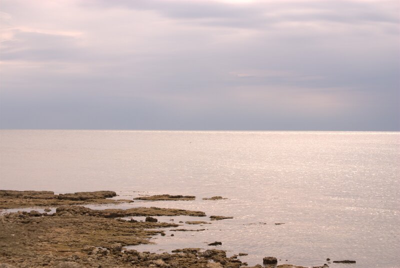 Rocky Shoreline at Sea — Gray, Calm, Sunset, Photograph