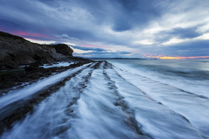 Rocky Shoreline at Sunset — Blue, Dramatic, Photograph, Ocean, Cliffs