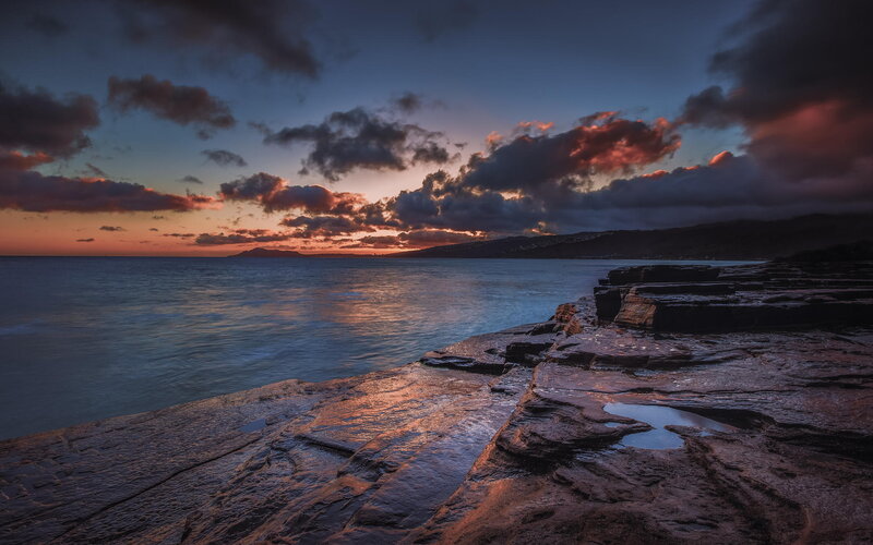 Rocky Shoreline at Sunset — Blue, Dramatic, Photograph, Ocean, Clouds, Mountain