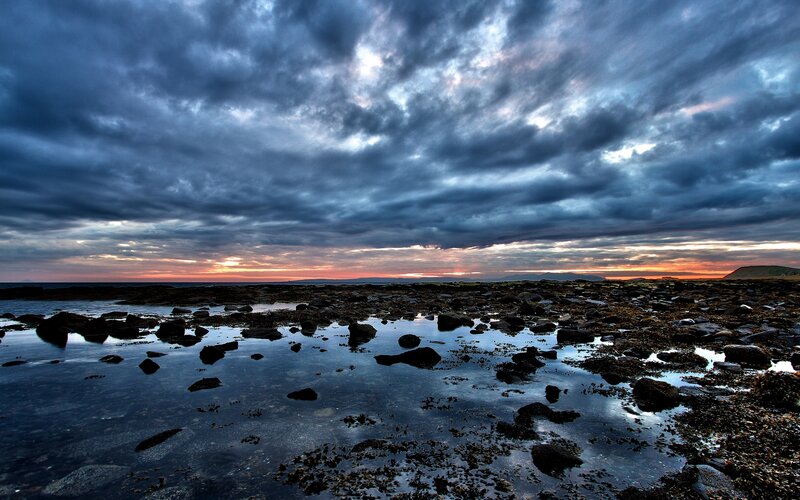 Rocky Shoreline at Sunset — Blue, Dramatic