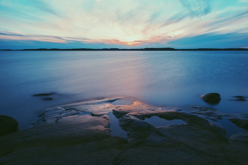 Rocky Shoreline at Sunset — Blue, Serene, Photograph, Rocks, Water, Sky