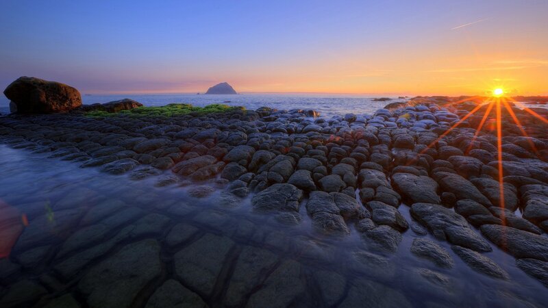 Rocky Shoreline at Sunset — Blue, Serene, Photograph, Sun, Ocean