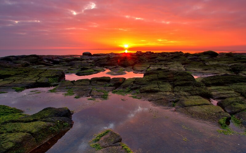 Rocky Shoreline at Sunset — Orange, Dramatic, Photograph