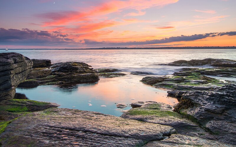 Rocky Shoreline at Sunset — Orange, Serene, Photograph, Ocean, Sky, Moon