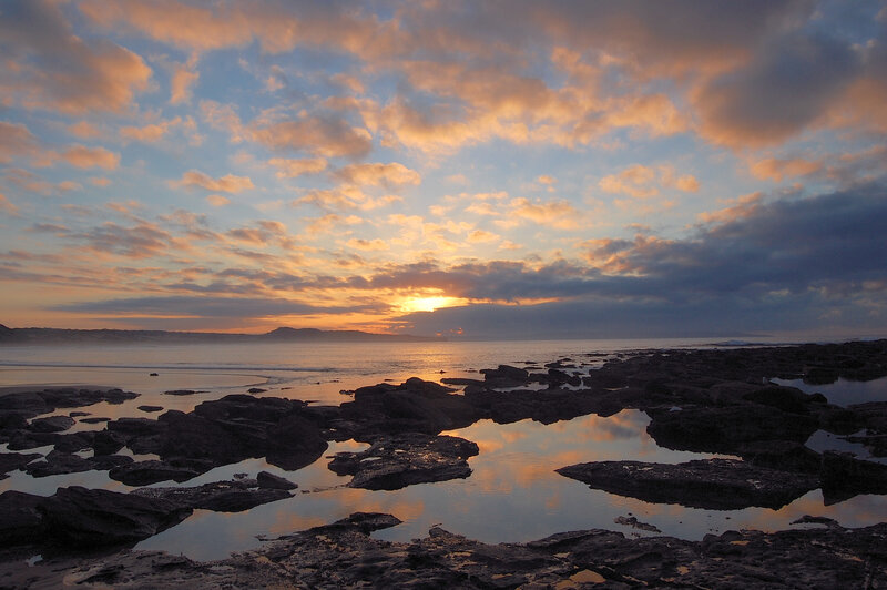 Rocky Shoreline at Sunset — Orange, Serene, Photograph, Ocean