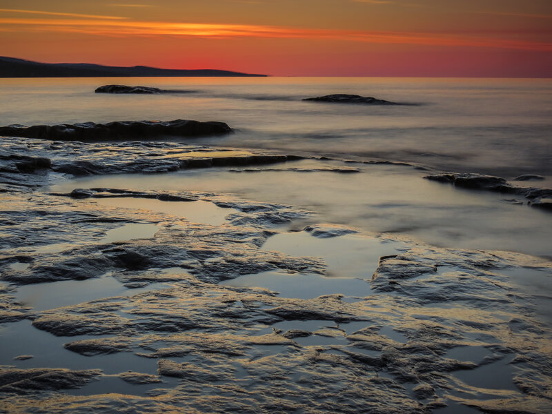 Rocky Shoreline at Sunset — Orange, Serene, Photograph, Rocks, Ocean, Sky