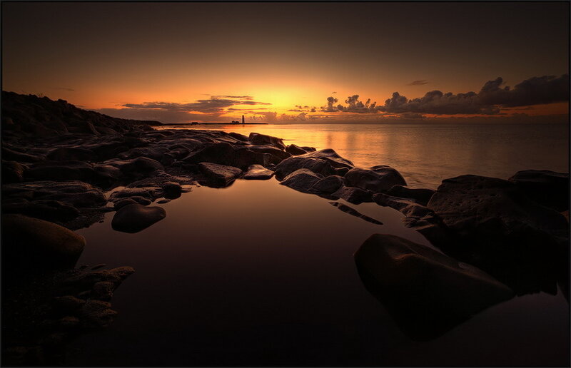 Rocky Shoreline at Sunset — Orange, Serene