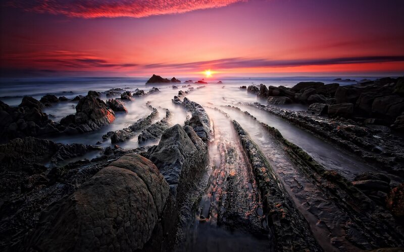 Rocky Shoreline at Sunset — Red, Dramatic, Photograph, Sun
