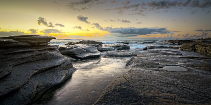 Rocky Shoreline at Sunset — Yellow, Serene