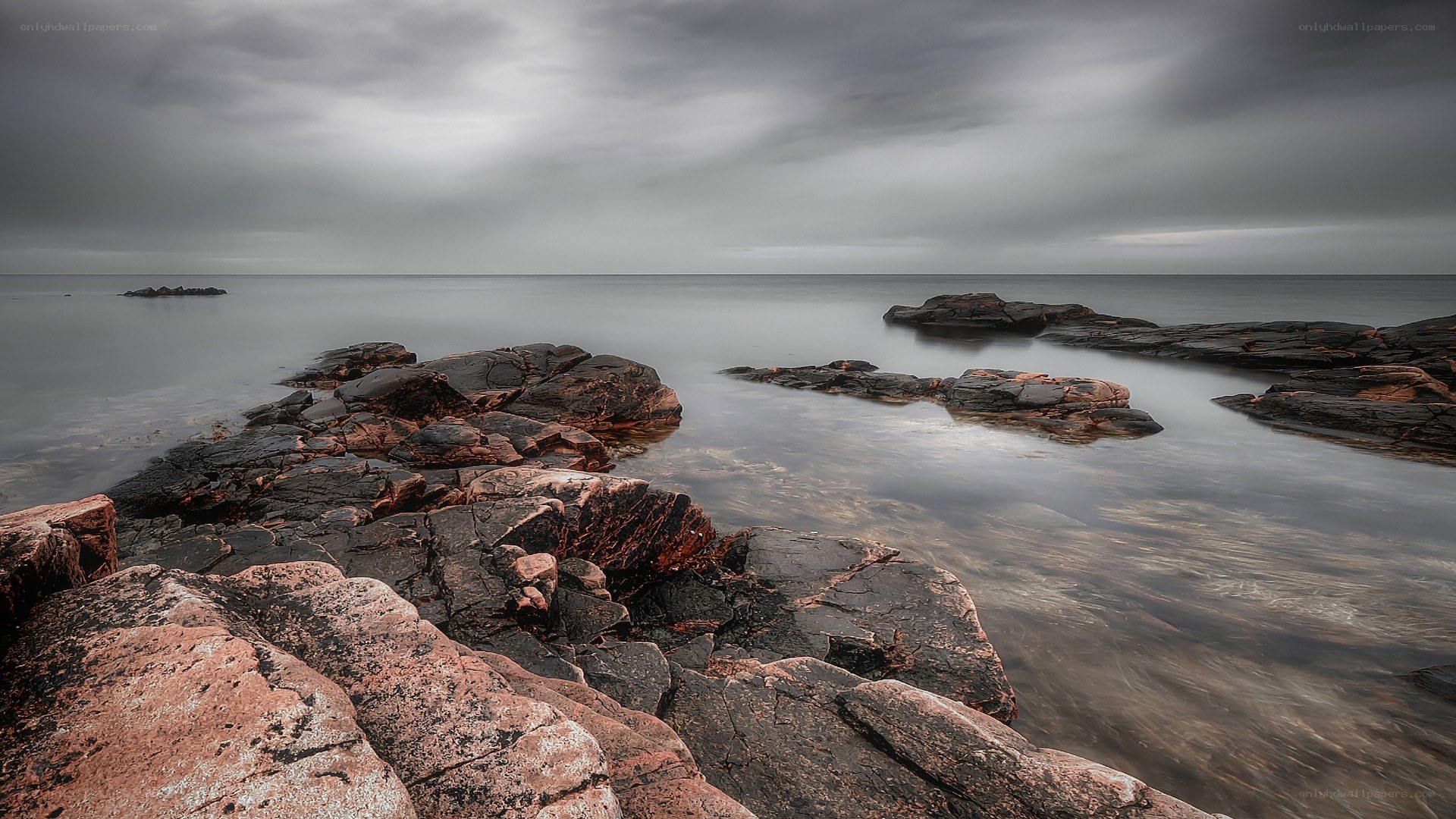 Rocky shoreline under cloudy sky