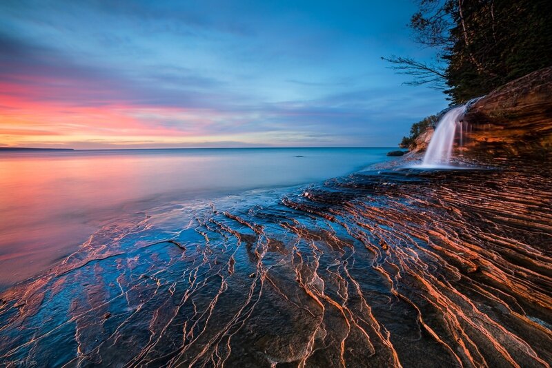 Rocky Shoreline Waterfall — Blue