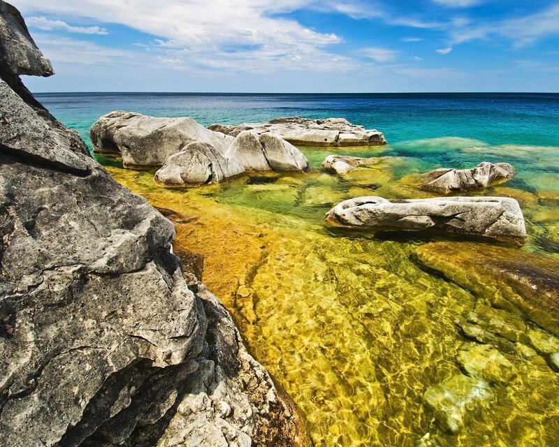 Rocky Shoreline with Clear Water — Blue