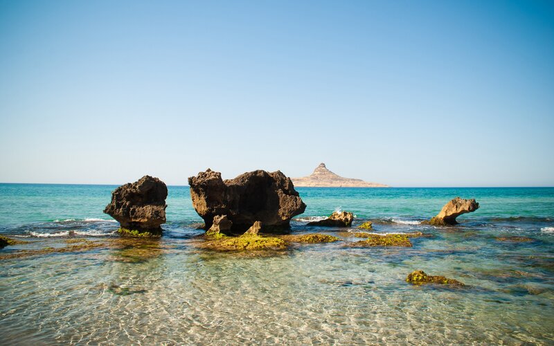 Rocky shoreline with distant island