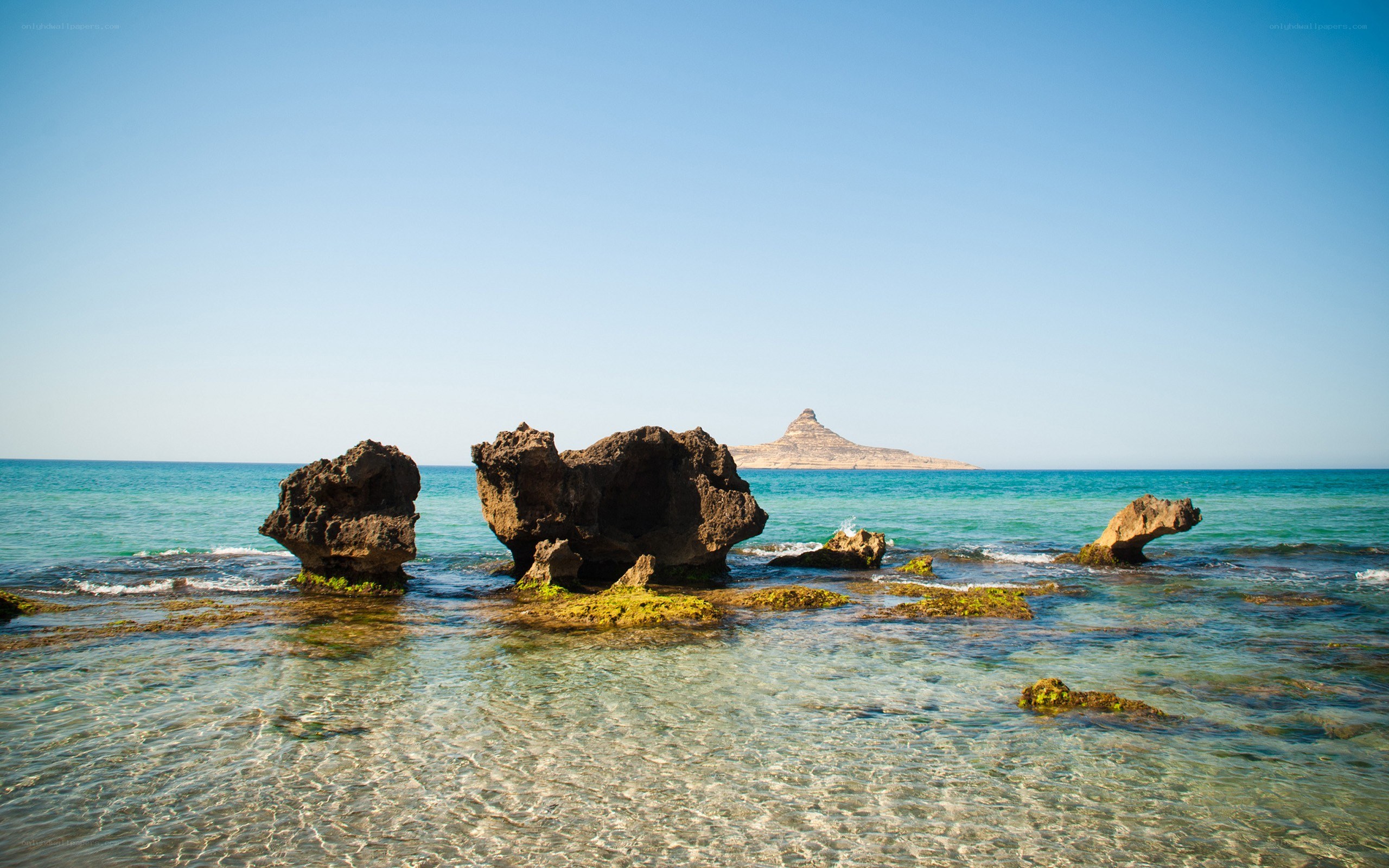Rocky shoreline with distant island