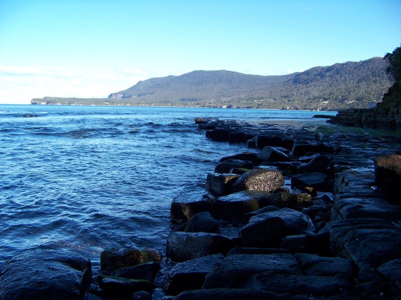 Rocky shoreline with distant mountains