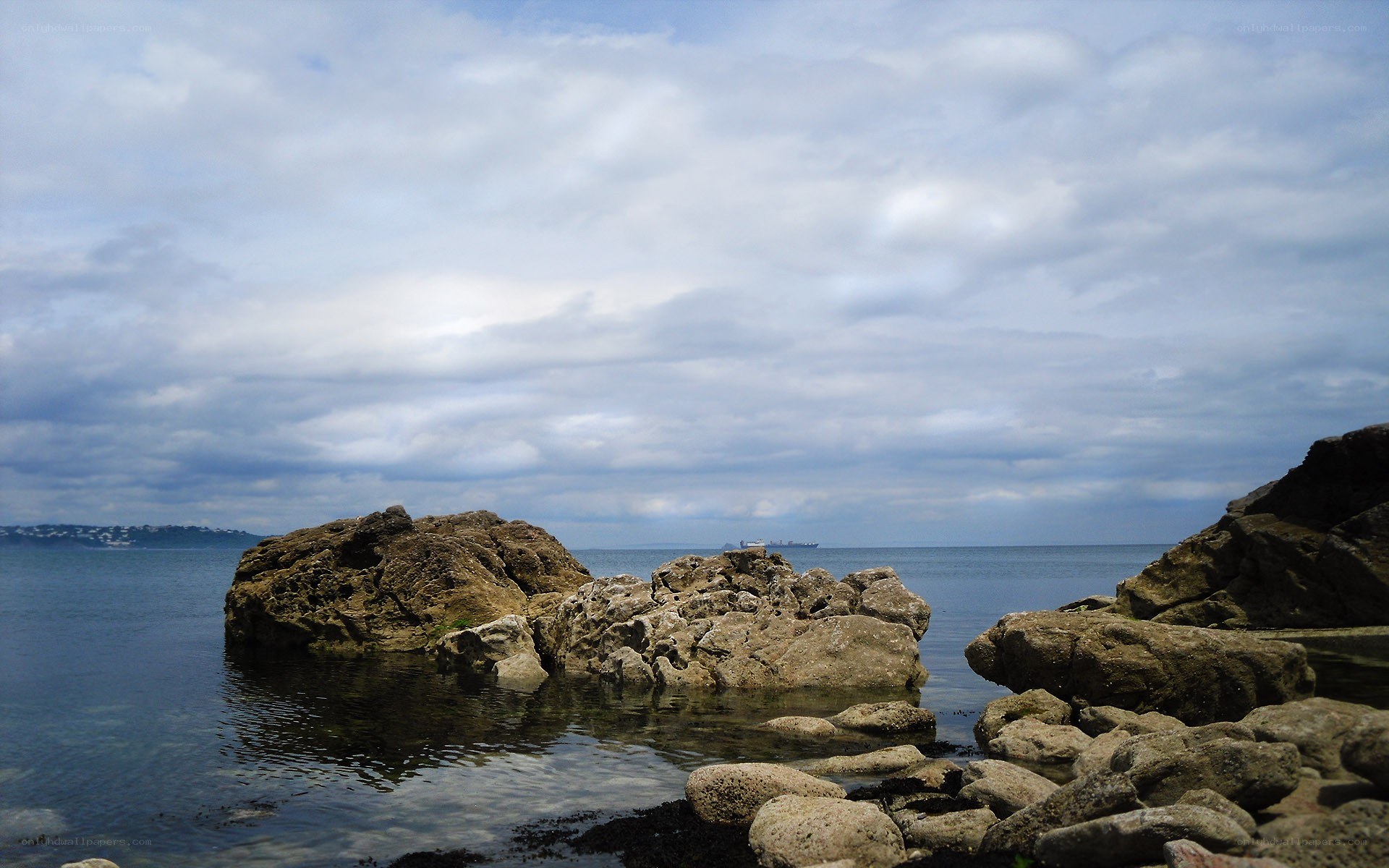 Rocky shoreline with distant ship