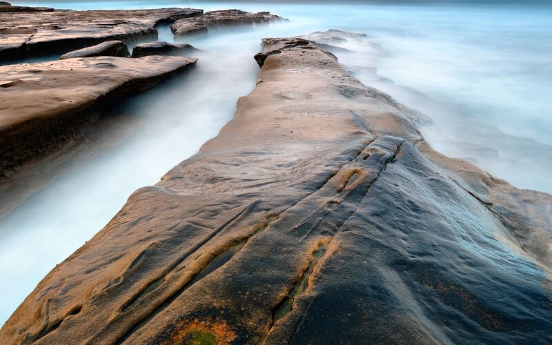 Rocky shoreline with flowing water