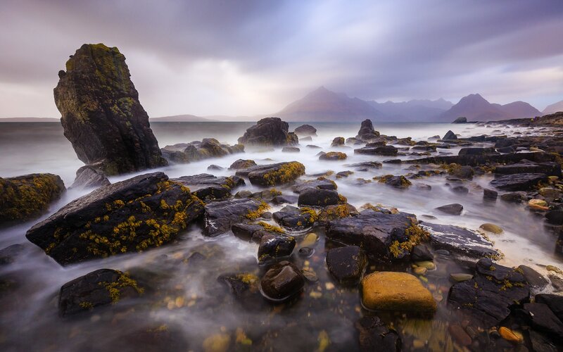 Rocky Shoreline with Mountains