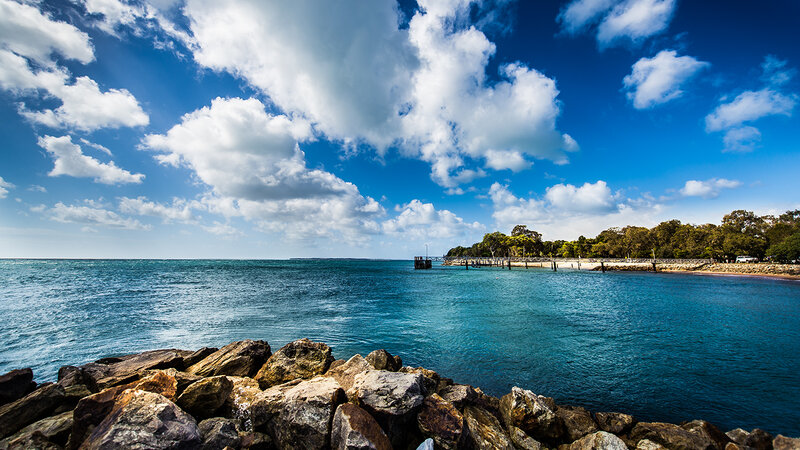 Rocky Shoreline with Pier — Blue, Serene