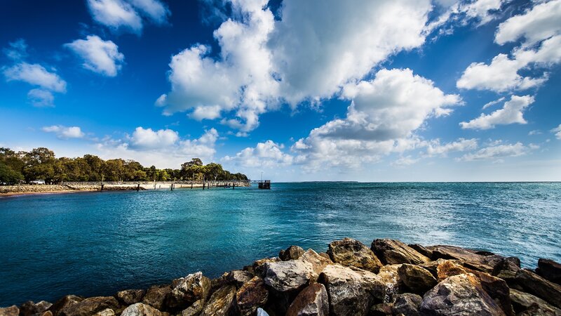 Rocky Shoreline with Pier — Blue
