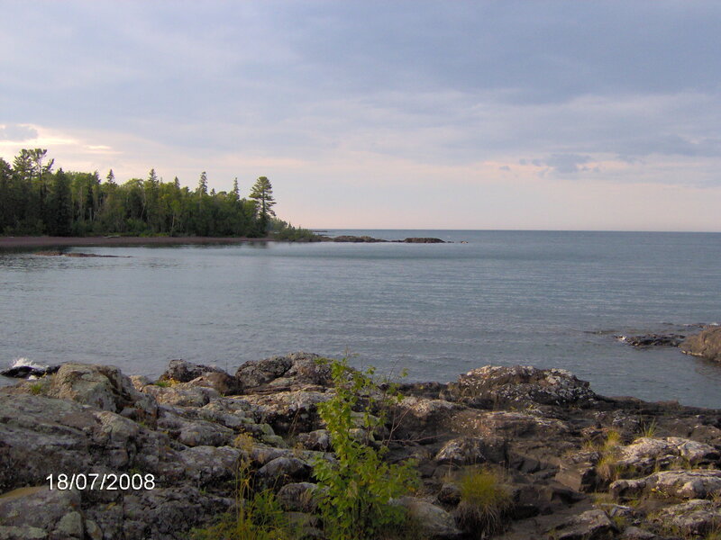 Rocky Shoreline with Trees — Blue, Serene, Afternoon