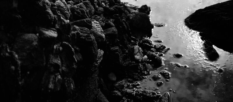 Rocky Shoreline with Water — Black