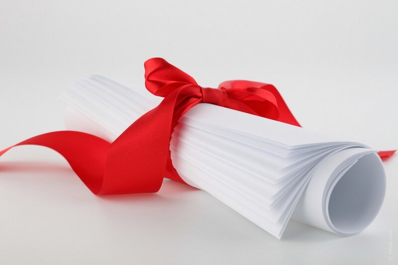 rolled diploma with red ribbon