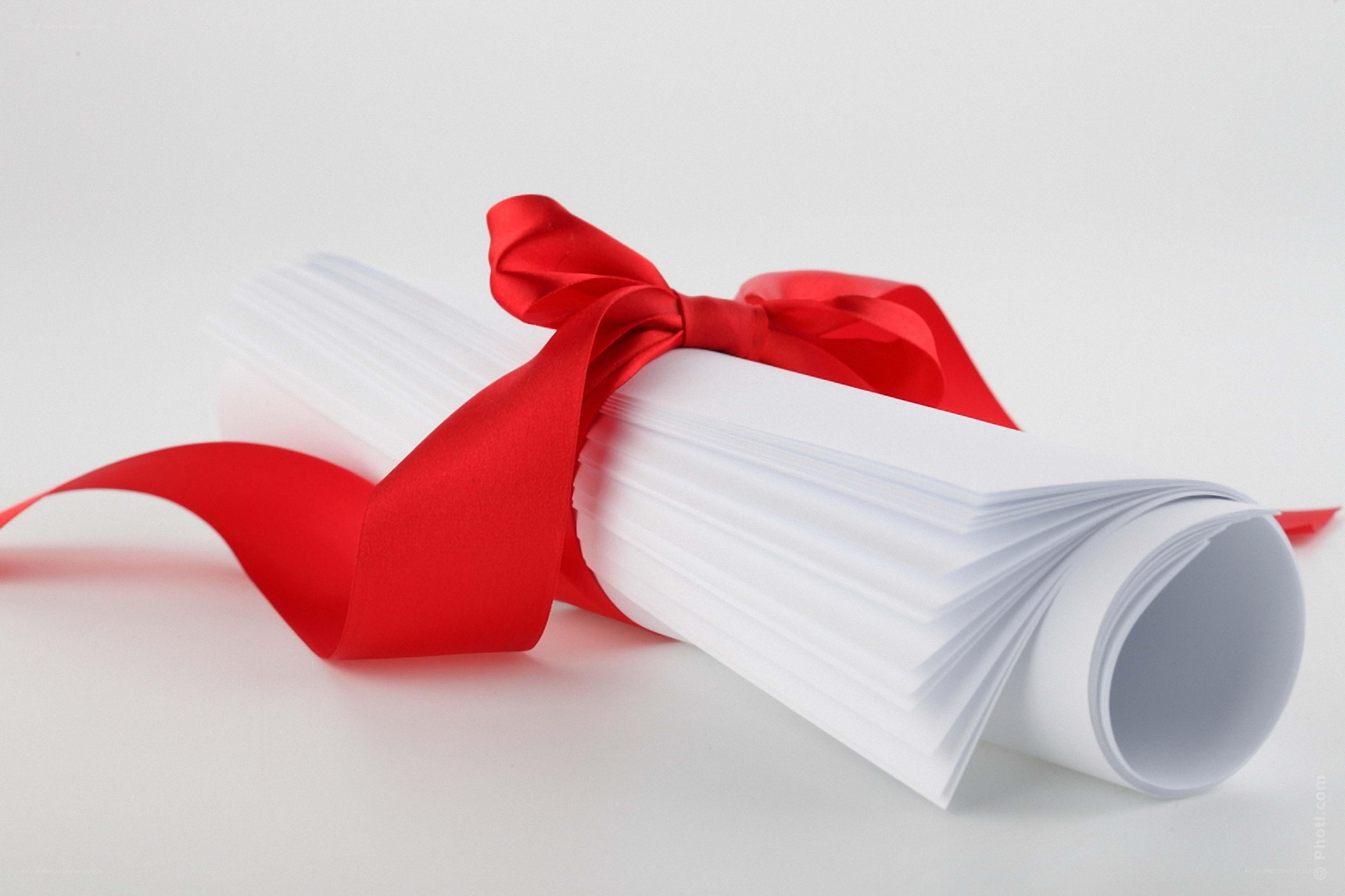 rolled diploma with red ribbon