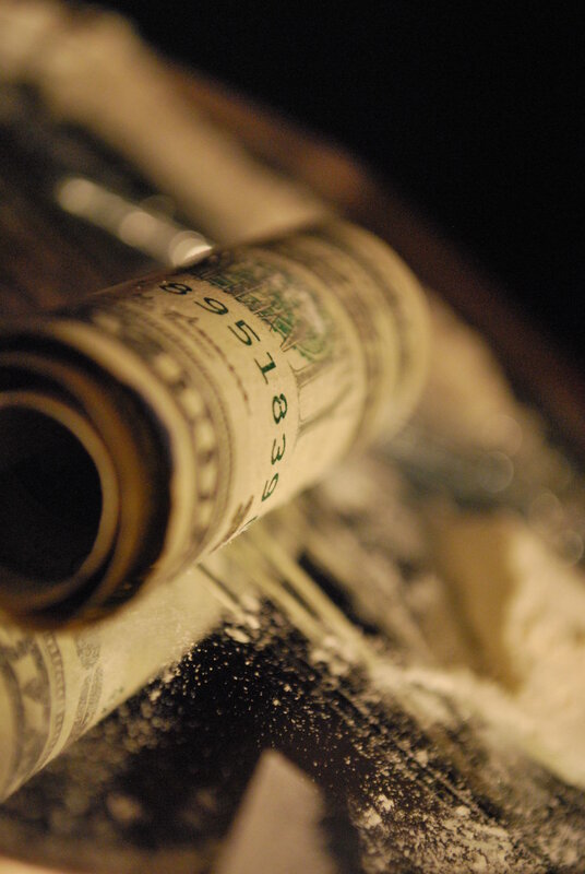 rolled money and white powder