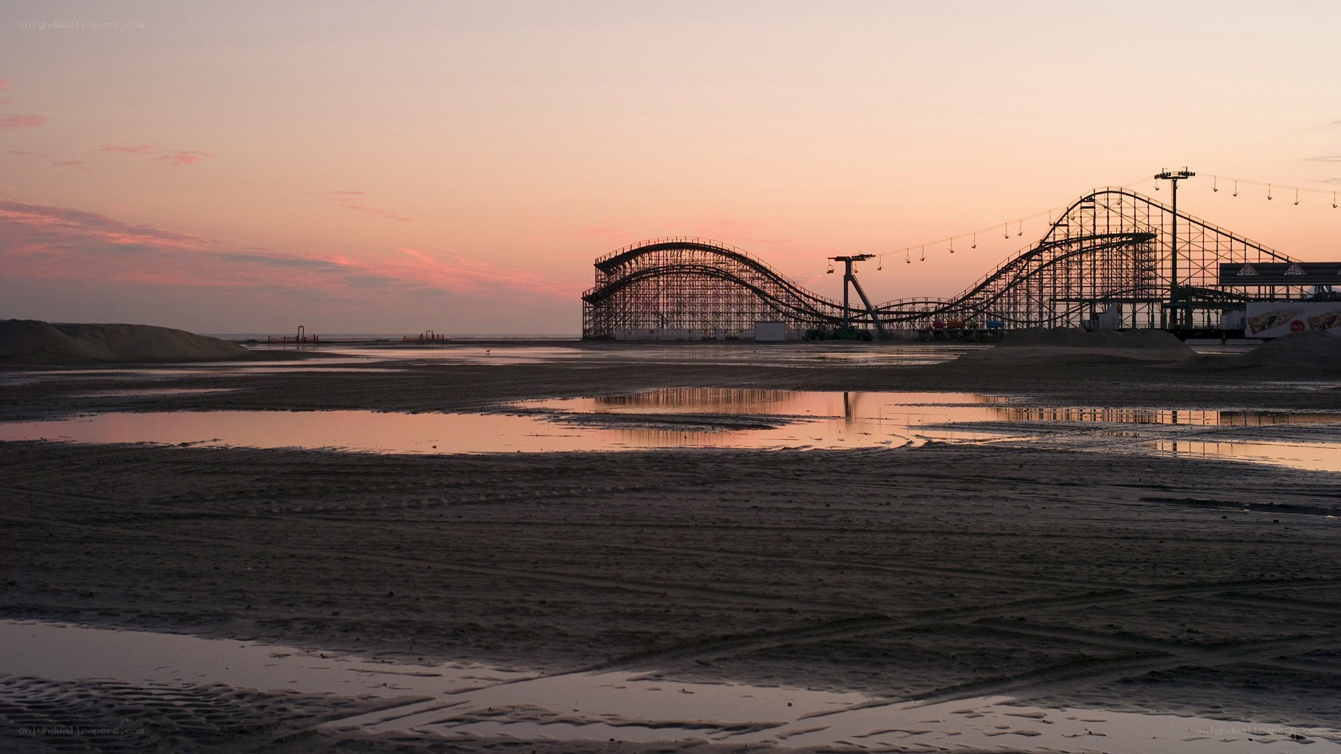 Roller coaster at sunset on beach