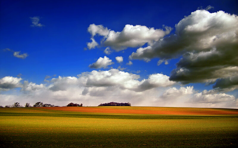 Rolling Fields under Clouds — Blue, Dramatic