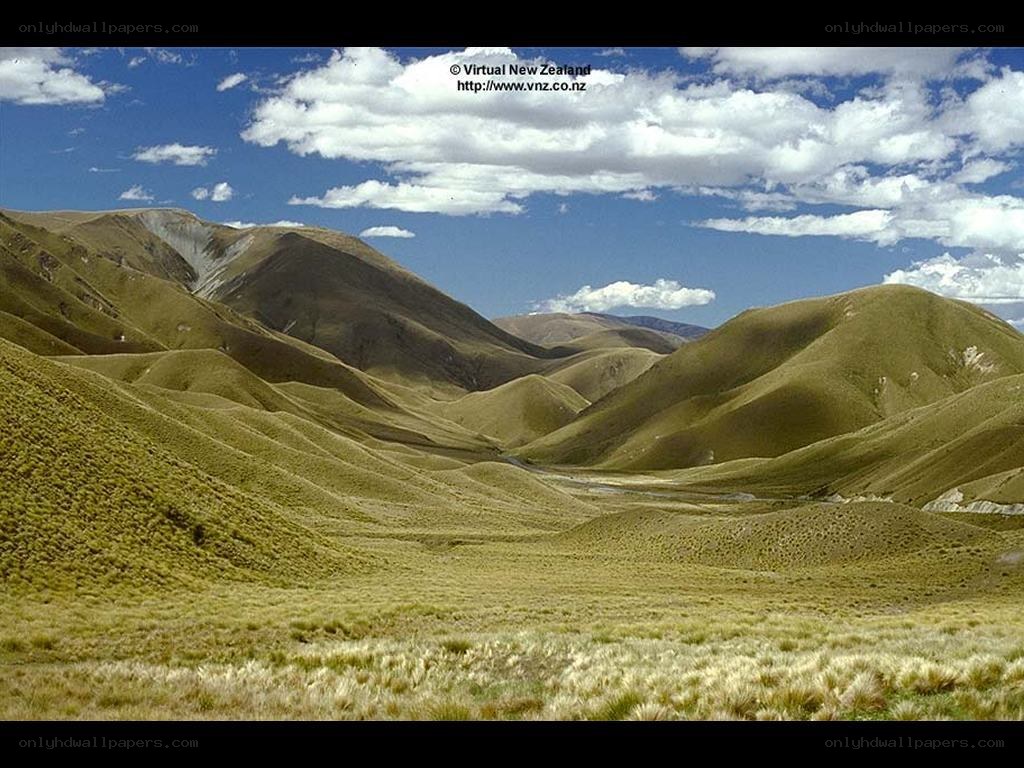 Rolling green hills under blue sky