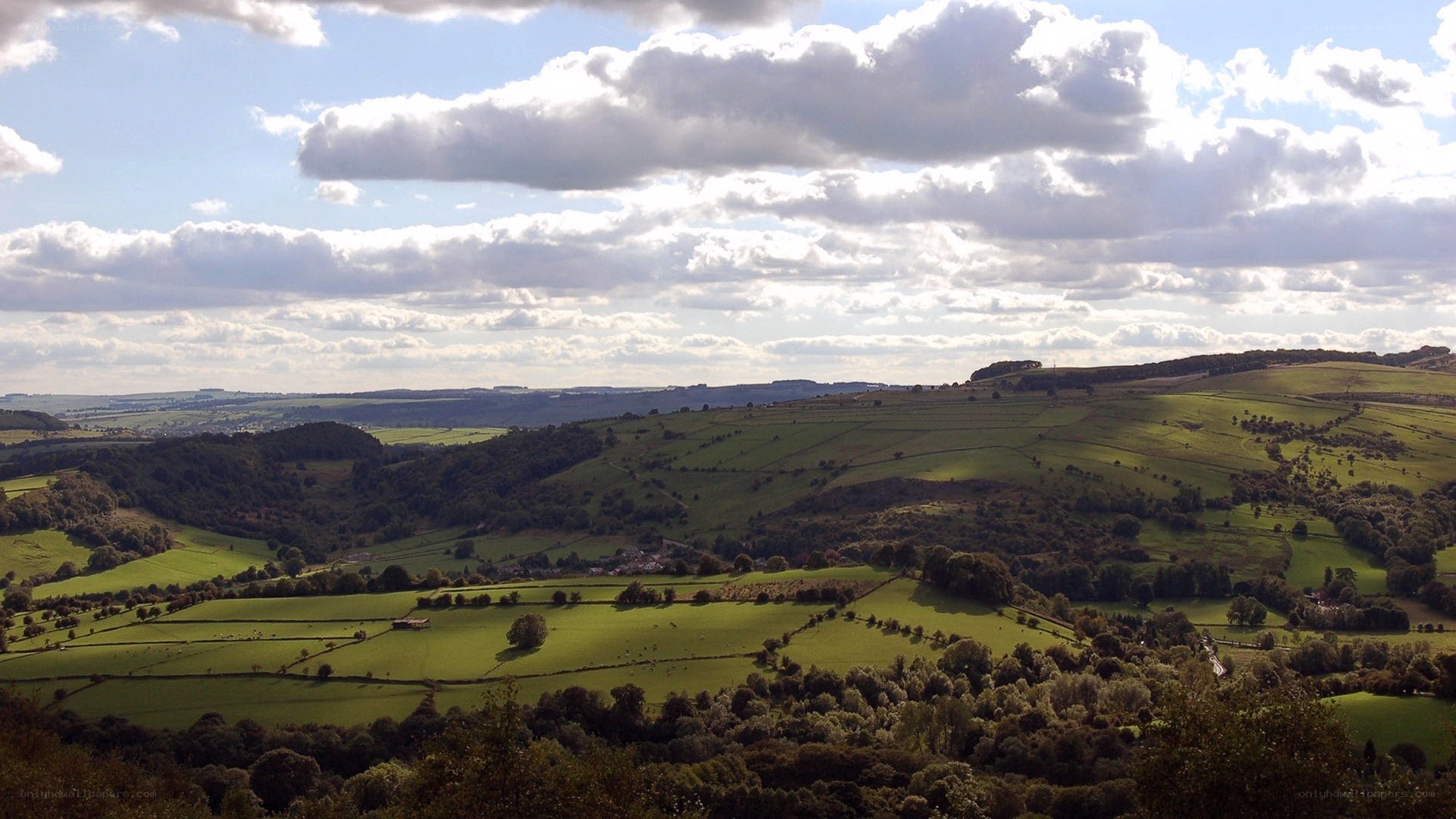 rolling green hills under cloudy sky
