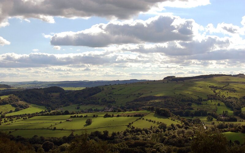 rolling green hills under cloudy sky