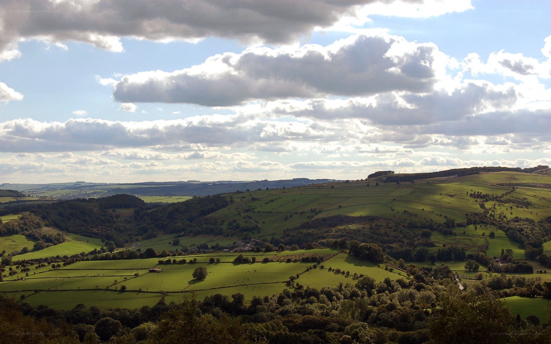 rolling green hills under cloudy sky